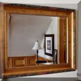DM08. Beveled glass mirror with floral surround. 